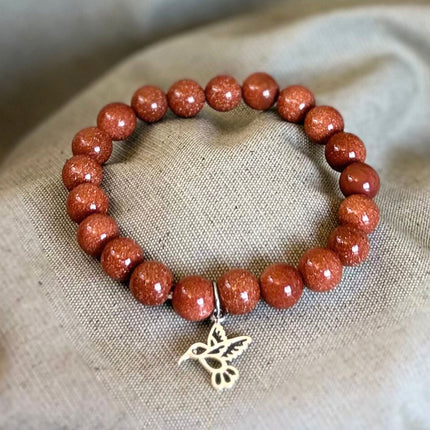 Pulsera Goldstone con Charm Colibrí