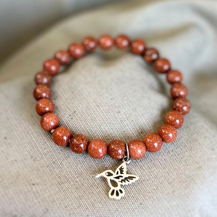 Pulsera Goldstone con Charm Colibrí